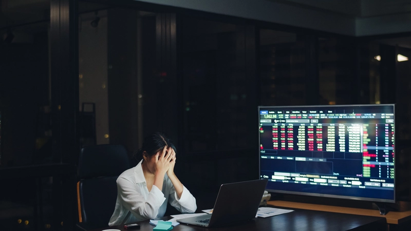 Security analyst overwhelmed by high-volume alerts across multiple monitors, showing how alert fatigue can hide real threats and lead to missed incidents in a modern SOC.